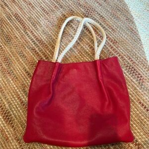 Red leather bag with white accents and stitching